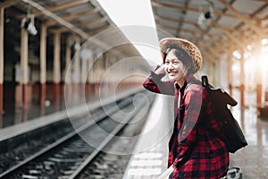 Young traveler woman looking for friend planning trip at train station. Summer and travel lifestyle concept