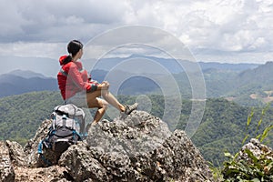 Young traveler woman with stylish backpack  looking forward at amazing mountains view. Enjoying nature, relax, pleasure