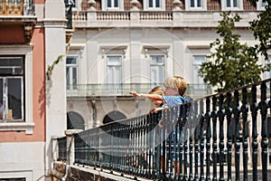 Young travelers at Lisbon viewpoint pointing with fingers