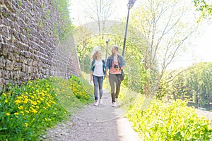 Young travelers walking in a park. Man and woman having vacation. Backpackers, traveling and tourism.