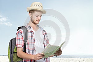 Young traveling man reading map