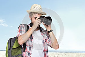 Young traveling man taking a picture