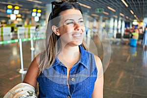 Young traveller woman at the airport going on vacation