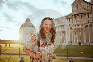 Young traveller woman in floral dress having excursion