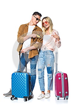 young travelling couple with suitcases and credit card