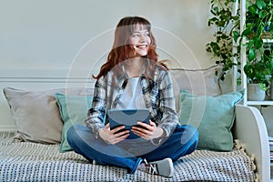 Young trendy girl using digital tablet for studying communication leisure