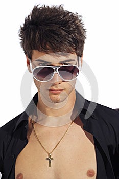 Young trendy guy. Italian man with big sunglasses and open black shirt