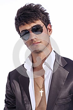 Young trendy guy. Italian man with sunglasses and open white shirt