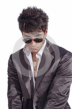 Young trendy guy. Italian man with sunglasses and open white shirt