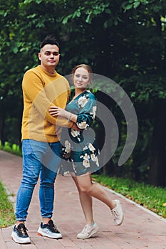 Young and trendy man and woman models walks on the street. in old town. Fashion Style.