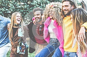 Young trendy people having fun outdoor - Happy friends laughing and talking together in city park - Youth, millennial generation,