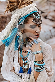 Young tribal style woman with lot of boho accessories portrait