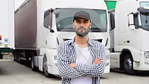 Young truck driver is with his vehicle at daytime