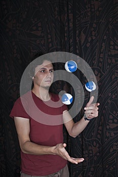 Young turkish guy playing juggling balls