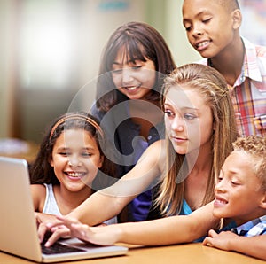 Young tutor, laptop and teaching children. kids or pupils technology, social media or research in class. Group of