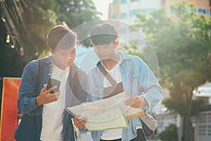 Young two men travel together in city on summer vacation