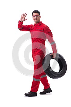 Young tyre repairman in red coveralls isolated on white backgrou