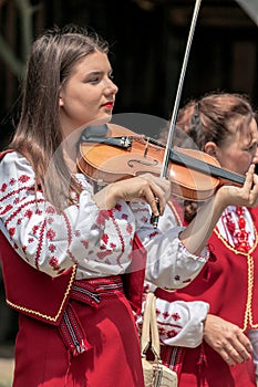 Young Ukrainian girl violin singer from Banat, in traditional co