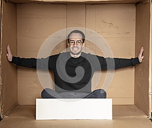 Young unemployed man holding a white board, a place for advertising, the idea of a cry for help