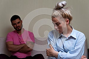 Young unhappy couple having relations problems