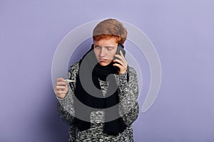 Young unhappy sad man making a phone call. Cold and Sickness