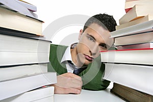 Young unhappy student with stacked books