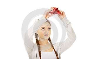 Young unhappy woman with empty purse.