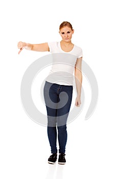 Young unhappy woman showing thumb down