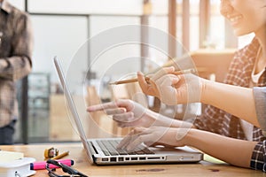 young university students studying with computer in cafe. Group