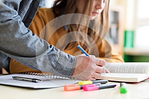 Young unrecognisable teacher helping his student in class. Education and Tutoring.