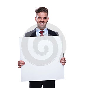 Young unshaved businessman holds an empty billboard