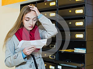 Young upset woman in coat receiving ugly news