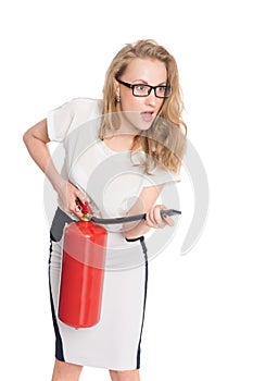 Young uptight woman with a fire extinguisher