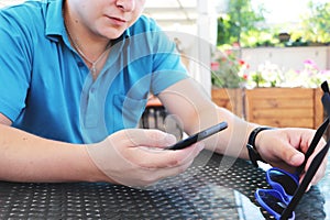 Young urban professional man using smart phone. Businessman holding mobile smartphone using app texting sms message