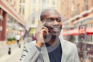 Young urban professional smiling man using smart phone