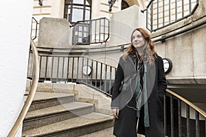 Young Urbanite Woman Standing on Outdoor Staircase photo