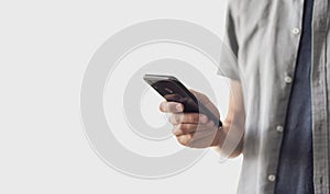 Young using smart phone. Businessman texting on mobile phone isolated on grey background