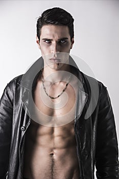 Young Vampire Man in an Open Black Leather Jacket, Showing his Chest and Abs