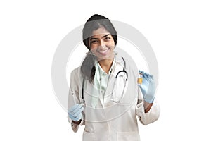 Young Venezuelan female doctor holding a syringe and a vial, isolated.