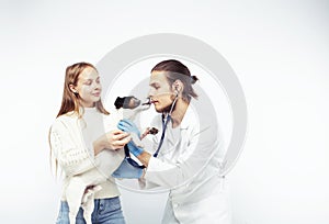 Young veterinarian doctor in blue gloves examine little cute dog jack russell isolated on white background with owner