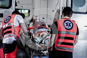 Young victim of the accident lies on a stretcher in an ambulance