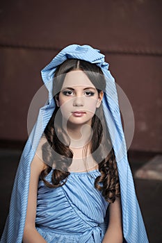 Young victorian lady in a blue cape