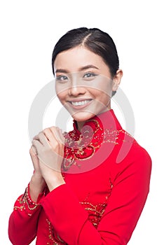 Young vietnamese woman in Ao Dai Dress with praying gesture wish