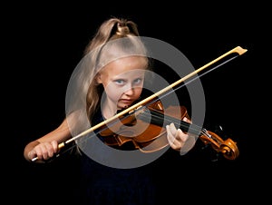Young violinist with piercing gaze isolated on black background