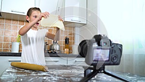 Young vlogger recording content for food blog rolling dough with rolling pin