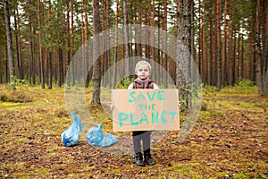 Young volunteer child cleaning forest environment from rubbish pollution