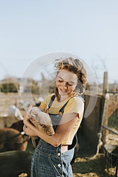 Young volunteer with a piglet, The Sanctuary at Soledad, Mojave photo