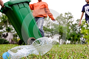 Young volunteers with garbage bags cleaning area in dirty beach of the lake, Volunteer concept.