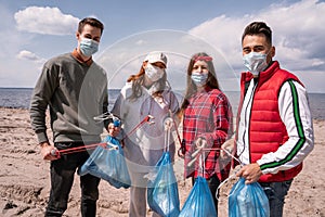 young volunteers in medical masks holding