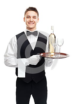 Young waiter with bottle of wine on tray